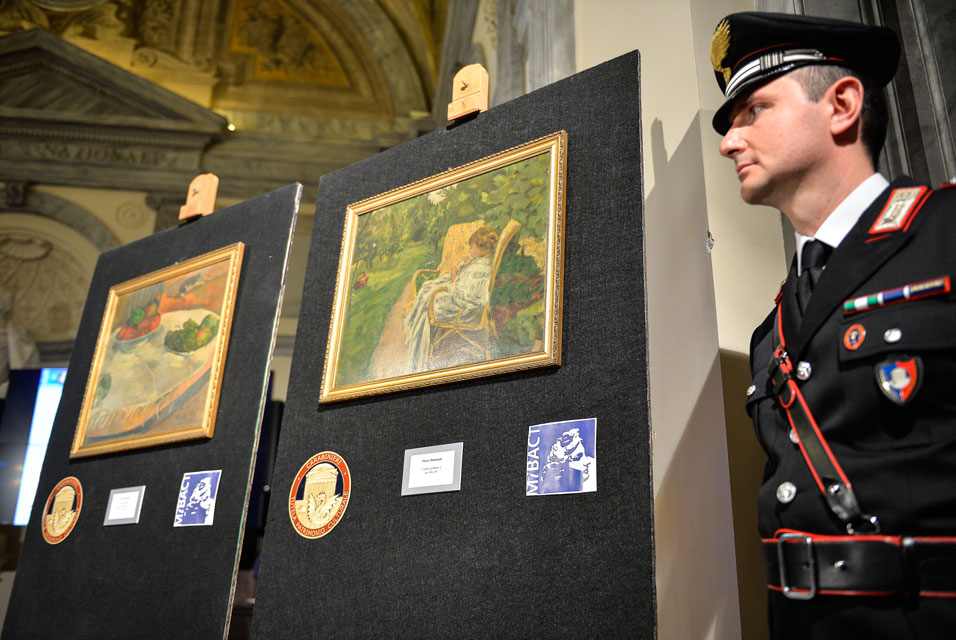  Italian police near the paintings of Paul Gauguin and Pierre Bonnard , found in Italy in the home of a former factory worker 